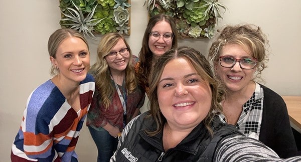 Group of staff members smiling for a picture