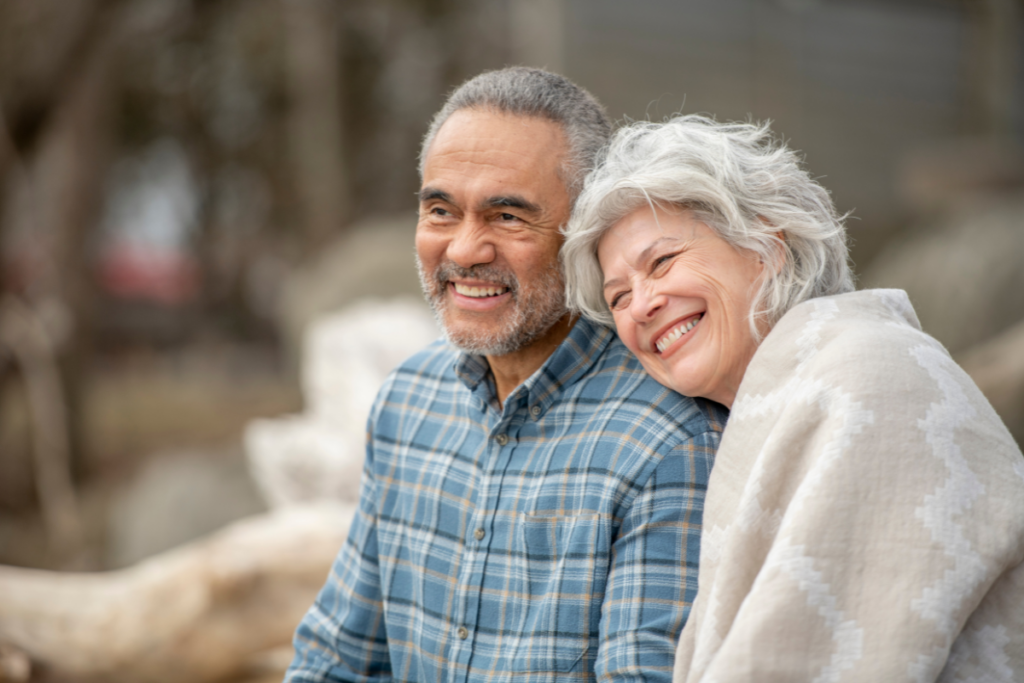 elderly couple smiling at the park