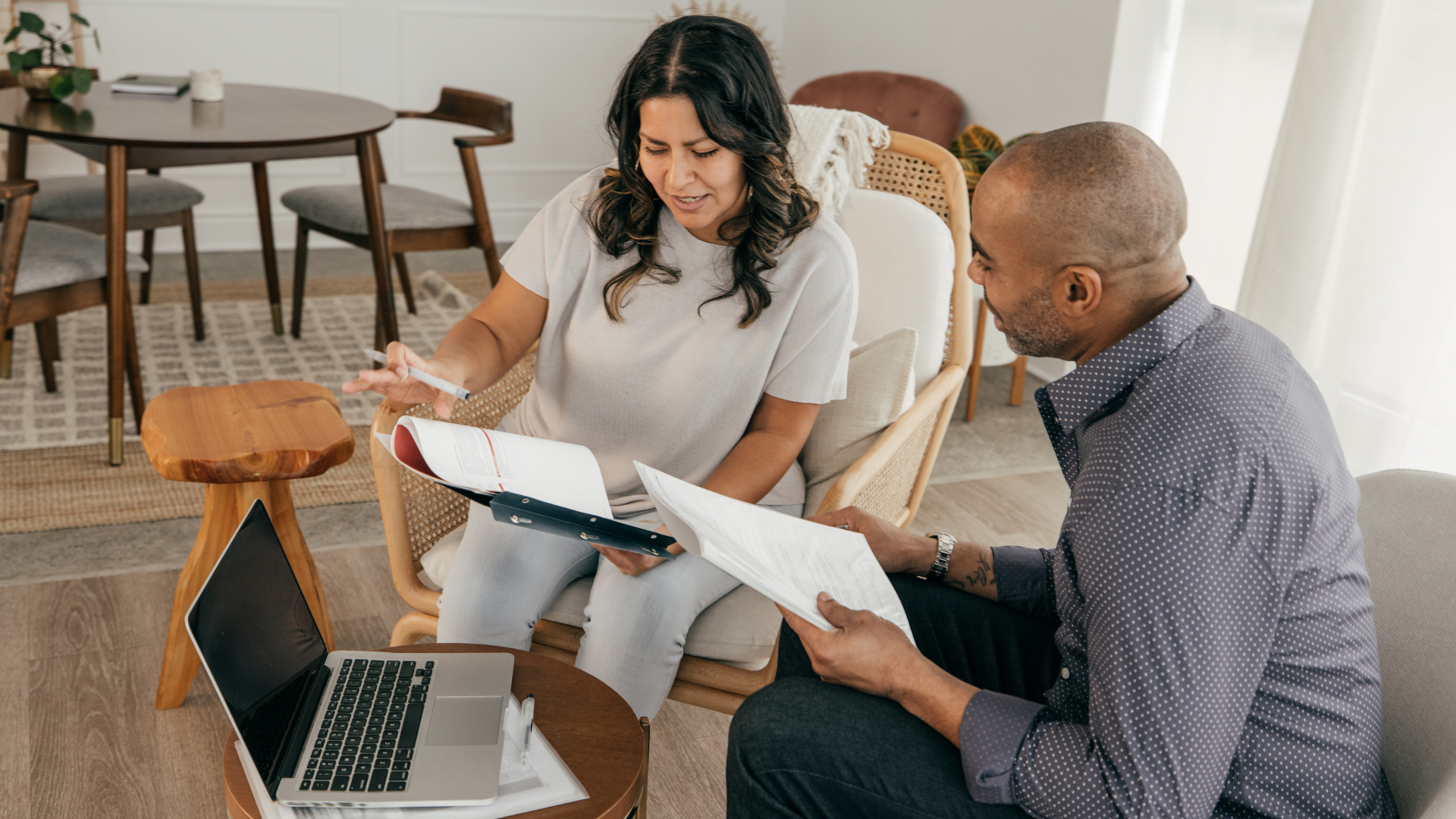 couple in their living room looking over their budget/financials