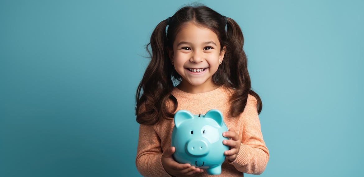 Girl holding piggy bank.
