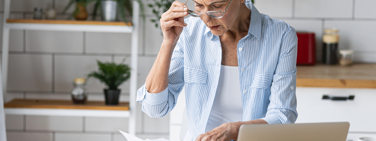 Woman with glasses looking at paperwork
