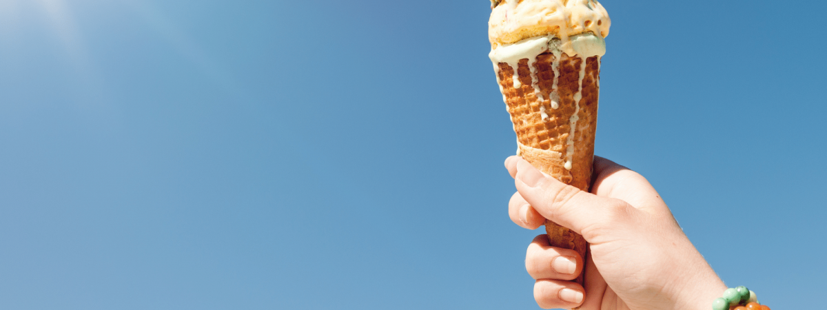 ice cream in a hand pointing to the sky